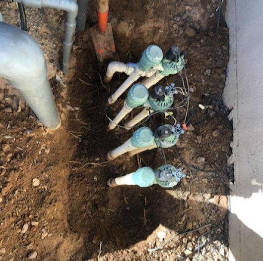 Before: four old anti-siphon valves buried in the dirt